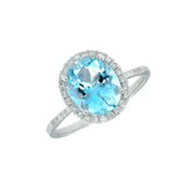 14K White Gold 3.20ct Oval Blue Topaz Ring with Diamond Halo & Side Diamonds. Bichsel Jewelry in Sedalia, MO. Shop gemstone rings online or in-store today!