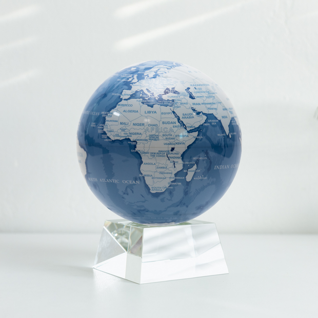 6" Sky Blue and White MOVA Globe with Acrylic Base. Powered by Solar Ambient Light & Magnets. No cords or batteries needed. Shop online or in-store today!