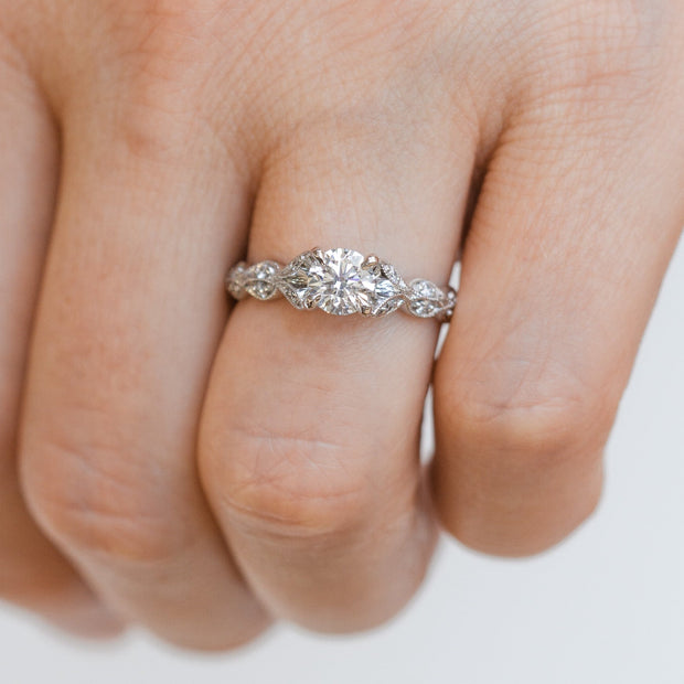 14K White Gold 0.65ct Round Diamond Engagement Ring with 0.16ct Laurel Leaves Diamond Accent Band. Free in-store ring sizing. Free Preferred Jewelers Warranty. Bichsel Jewelry in Sedalia, MO.