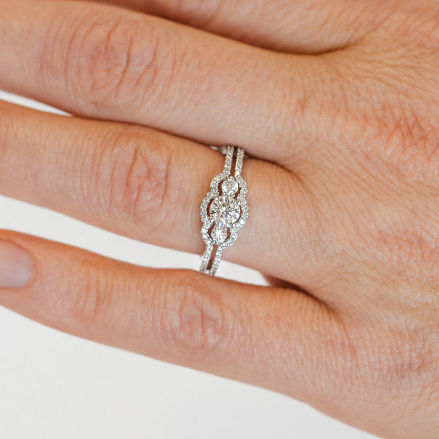 14K White Gold Round Three-Stone Diamond Engagement Ring with Diamond Halo and Split Shank. Free Preferred Jewelers Warranty. Bichsel Jewelry in Sedalia, MO. Shop online or in-store today!