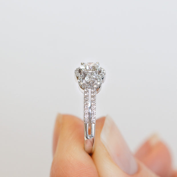 14K White Gold Round Three-Stone Diamond Engagement Ring with Diamond Halo and Split Shank. Free Preferred Jewelers Warranty. Bichsel Jewelry in Sedalia, MO. Shop online or in-store today!