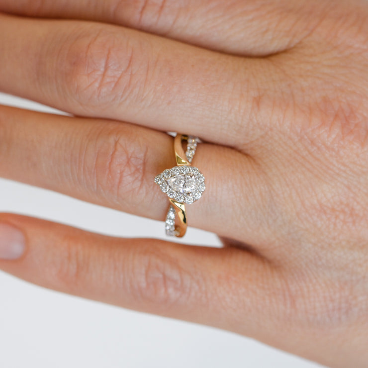 14K Yellow Gold Pear Diamond Engagement Ring with Halo & Twist Sides. Free Preferred Jewelers Warranty. Bichsel Jewelry in Sedalia, MO. Shop online or in-store today!