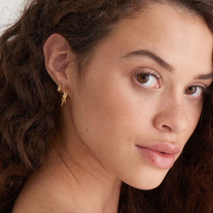 Ania Haie Gold Knot Stud Hoop Earrings. 14K yellow gold plated on 925 sterling silver. Bichsel Jewelry in Sedalia, MO. Shop styles online or in-store today!