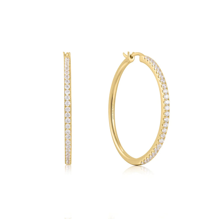 Ania Haie Gold Pavé Hoop Earrings. 14K yellow gold plated on sterling silver with Cubic Zirconia stones. Bichsel Jewelry in Sedalia, MO. Shop styles online or in-store today! 