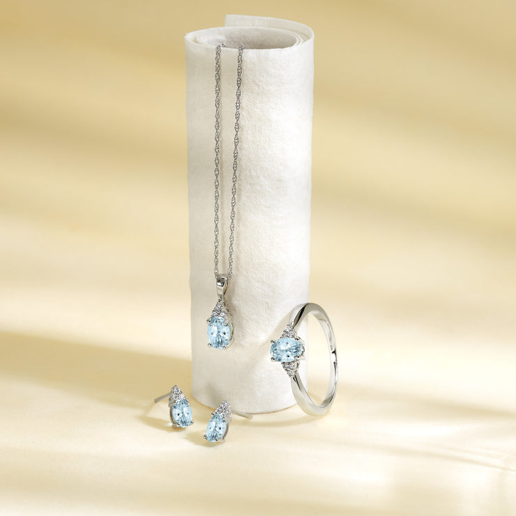 10K White Gold Oval Blue Topaz Ring with Round Diamond Accents. Bichsel Jewelry in Sedalia, MO. Shop online or in-store today!