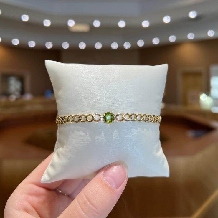 14K Yellow Gold Curb Chain Bracelet with 6mm Round Peridot Stone. Bichsel Jewelry in Sedalia, MO. Shop gemstone styles online or in-store today!