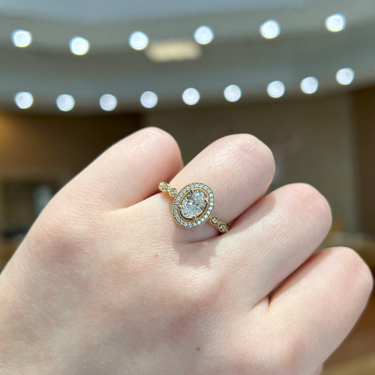 14K Yellow Gold Vintage-Inspired Oval Diamond Engagement Ring with Diamond Halo & Accent Stones. Bichsel Jewelry in Sedalia, MO. Shop online or in-store today!