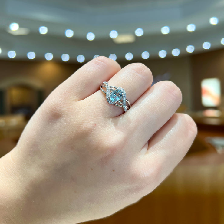 14K White Gold 0.67ct Oval Aquamarine Crossover Ring with Diamond Accents. Bichsel Jewelry in Sedalia, MO. Shop gemstone rings online or in-store!