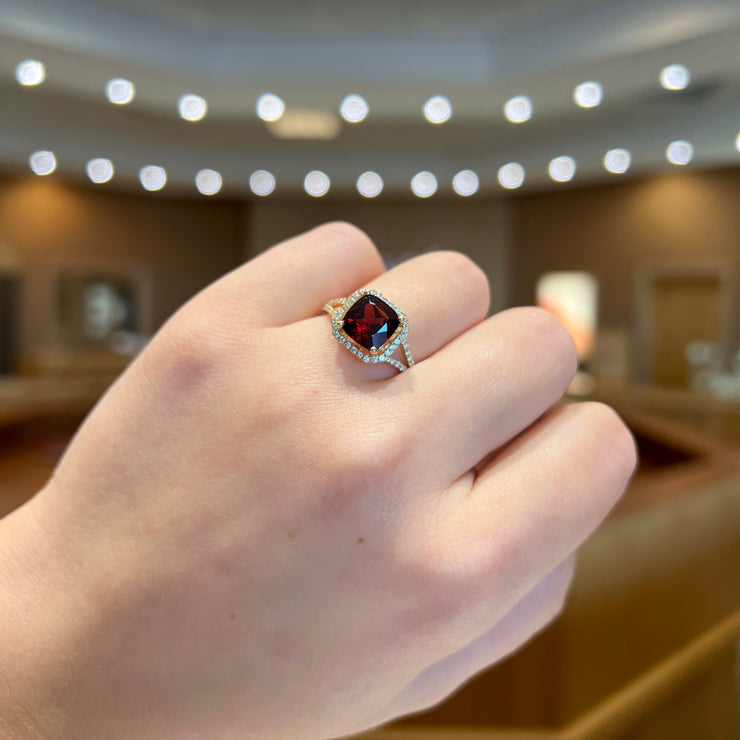 14K Yellow Gold Cushion Cut Garnet Split Shank Ring with Diamond Halo & Side Diamonds. Bichsel Jewelry in Sedalia, MO. Shop rings online or in-store! Free ring sizing.