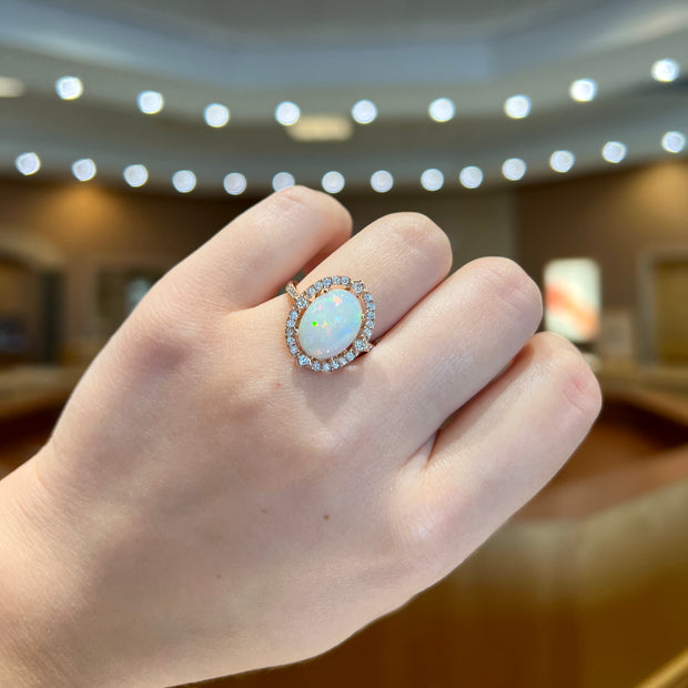 14K Rose Gold 3.00ct Oval Opal Ring with Diamond Halo. Bichsel Jewelry in Sedalia, MO. Shop gemstone rings online or in-store today!