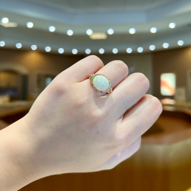 14K Rose Gold 3.00ct East-West Oval Opal Ring with Diamond Halo. Bichsel Jewelry in Sedalia, MO. Shop gemstone rings online or in-store today!