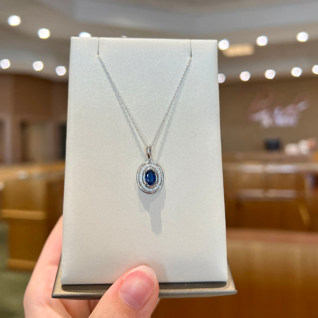 14K White Gold Oval 0.65ct Blue Sapphire Necklace with Round Diamond Halo. Bichsel Jewelry in Sedalia, MO. Shop gemstone styles online or in-store today!
