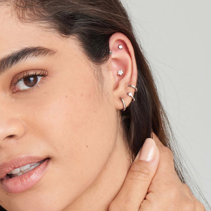 Ania Haie Silver Mini Huggie Hoop Earrings. Rhodium plated 925 sterling silver. Bichsel Jewelry in Sedalia, MO. Shop styles online or in-store today!