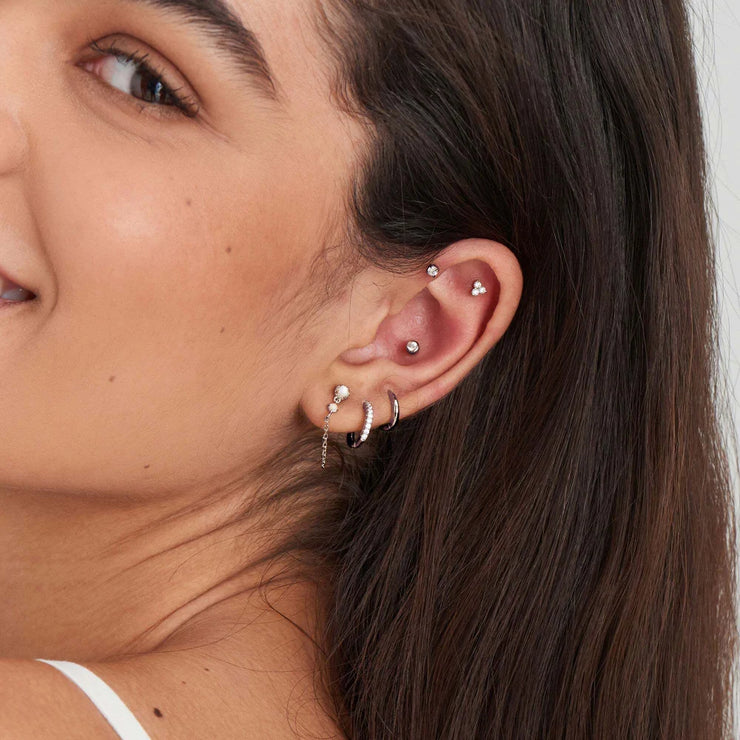 Ania Haie Silver Mini Huggie Hoop Earrings. Rhodium plated 925 sterling silver. Bichsel Jewelry in Sedalia, MO. Shop styles online or in-store today!