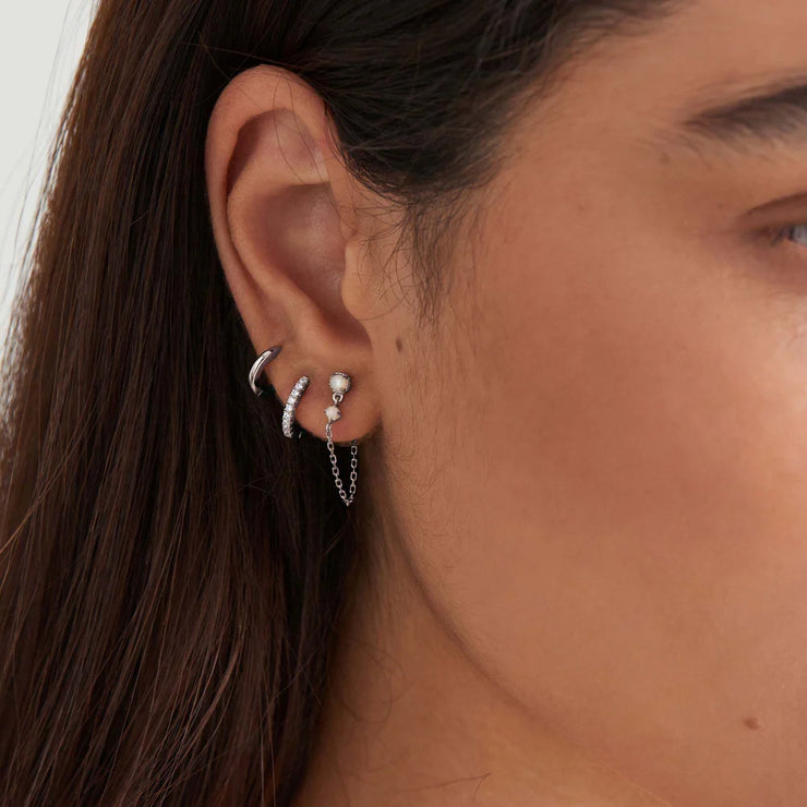Ania Haie Silver Mini Huggie Hoop Earrings. Rhodium plated 925 sterling silver. Bichsel Jewelry in Sedalia, MO. Shop styles online or in-store today!