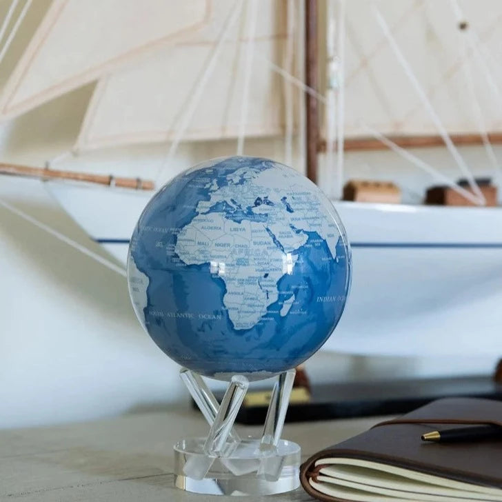 6" Sky Blue and White MOVA Globe with Acrylic Base. Powered by Solar Ambient Light & Magnets. No cords or batteries needed. Shop online or in-store today!