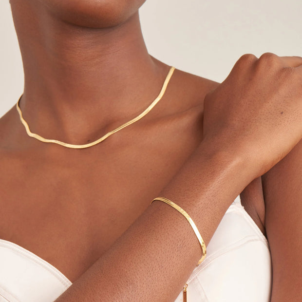Ania Haie Gold Herringbone Chain Bracelet, 925 sterling silver with 14K yellow gold plating. Bichsel Jewelry in Sedalia, MO. Shop styles online or in-store today!